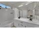 Bright bathroom with double sinks, tub, shower, and neutral tile, a perfect blend of style and functionality at 2558 Wiltshire Ave, Henderson, NV 89052