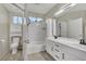 Neutral bathroom with double sinks, tub, shower, and neutral tile, a perfect blend of style and functionality at 2558 Wiltshire Ave, Henderson, NV 89052