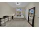 Bright bedroom with desk, full-length mirror, and comfortable daybed with decorative pillows at 2558 Wiltshire Ave, Henderson, NV 89052