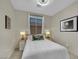 Cozy bedroom features a comfortable bed, stylish lamps, and tasteful decorations at 2558 Wiltshire Ave, Henderson, NV 89052