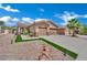 Inviting home with a stucco exterior, landscaped yard, and a driveway leading to a two-car garage at 2558 Wiltshire Ave, Henderson, NV 89052