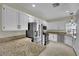 Bright kitchen with white cabinets, granite countertops, and stainless steel appliances at 2558 Wiltshire Ave, Henderson, NV 89052