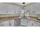 Bright kitchen with granite countertops, stylish lighting fixtures, and stainless dishwasher at 2558 Wiltshire Ave, Henderson, NV 89052