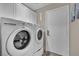 Convenient laundry room with a washer, dryer, and storage cabinets for organization at 2558 Wiltshire Ave, Henderson, NV 89052