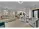 Open-concept living area with tile floors, modern furniture, and access to the kitchen at 2558 Wiltshire Ave, Henderson, NV 89052