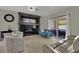 Bright living room with comfortable seating, a stylish entertainment center, and patio access at 2558 Wiltshire Ave, Henderson, NV 89052