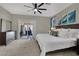 Main bedroom features a dresser, ceiling fan, and sliding glass doors for outdoor access at 2558 Wiltshire Ave, Henderson, NV 89052