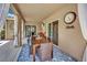 Cozy covered patio with outdoor dining, ideal for enjoying meals and gatherings in a relaxing backyard setting at 2558 Wiltshire Ave, Henderson, NV 89052