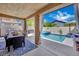Relaxing covered patio featuring outdoor dining, barbecue, and a refreshing pool with spa at 2558 Wiltshire Ave, Henderson, NV 89052