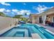 A refreshing backyard pool and spa create a relaxing outdoor oasis with a sunbed under the sun at 2558 Wiltshire Ave, Henderson, NV 89052