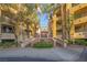 Multi-story condominium building with palm trees and manicured landscaping at 270 E Flamingo Rd # 131, Las Vegas, NV 89169