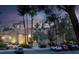 Community building with Spanish-style architecture, mature trees, and parking at 270 E Flamingo Rd # 131, Las Vegas, NV 89169