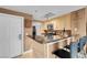 Bright kitchen featuring granite countertops, light wood cabinets, and breakfast bar at 270 E Flamingo Rd # 131, Las Vegas, NV 89169
