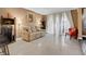Living room with tiled floors, sofa, red chair and owl art at 270 E Flamingo Rd # 131, Las Vegas, NV 89169