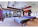 Billiards room features covered pool tables and beautiful views through large windows at 3124 Kookaburra Way, North Las Vegas, NV 89084