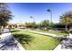 Well-maintained bocce ball court featuring artificial grass in a residential community, next to a tennis court at 3124 Kookaburra Way, North Las Vegas, NV 89084