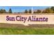 The Sun City Aliante sign with fresh green grass and a fountain with mountains in the background at 3124 Kookaburra Way, North Las Vegas, NV 89084