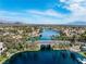 Stunning aerial view of a lakeside community with palm trees, bridges, and picturesque mountain views in the distance at 3151 Soaring Gulls Dr # 1062, Las Vegas, NV 89128