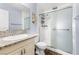 This clean bathroom has a granite vanity, a modern glass shower, and a decorative wall hanging at 3151 Soaring Gulls Dr # 1062, Las Vegas, NV 89128