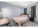 Cozy bedroom featuring plush carpet, a comfortable bed, and good natural light at 3151 Soaring Gulls Dr # 1062, Las Vegas, NV 89128