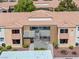 Two-story condo building with tile roof, neutral paint, and simple landscaping at 3151 Soaring Gulls Dr # 1062, Las Vegas, NV 89128