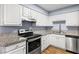 Kitchen with granite countertops, modern appliances, and stylish wood flooring at 3151 Soaring Gulls Dr # 1062, Las Vegas, NV 89128