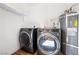 Modern laundry room with front loading washer and dryer and water heater at 3151 Soaring Gulls Dr # 1062, Las Vegas, NV 89128