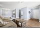 Bright living room featuring neutral walls, wooden floors, and a comfy couch at 3151 Soaring Gulls Dr # 1062, Las Vegas, NV 89128