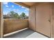 Enclosed outdoor patio area with a doorway and view of trees and other buildings at 3151 Soaring Gulls Dr # 1062, Las Vegas, NV 89128
