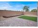 Backyard featuring brick pavers, artificial turf, a high brick wall, and gravel at 3712 Gilmore Creek St, Las Vegas, NV 89129