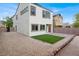 Back of house shows neutral paint, brick and gravel landscaping, with artificial turf at 3712 Gilmore Creek St, Las Vegas, NV 89129