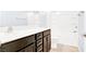 Modern bathroom with dark wood cabinets, chrome hardware, and a shower-tub combination at 3712 Gilmore Creek St, Las Vegas, NV 89129