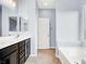 Bathroom featuring double sinks and a relaxing soaking tub at 3712 Gilmore Creek St, Las Vegas, NV 89129