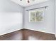 Well lit bedroom with hardwood floors and natural light from a large window at 3712 Gilmore Creek St, Las Vegas, NV 89129