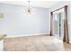 Dining area with view of backyard and modern lighting fixture at 3712 Gilmore Creek St, Las Vegas, NV 89129