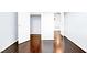 Hallway showcasing hardwood floors, neutral walls, and white doors leading to various rooms at 3712 Gilmore Creek St, Las Vegas, NV 89129