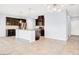 Spacious kitchen and living area with dark cabinetry, granite countertops, tile backsplash and modern lighting at 3712 Gilmore Creek St, Las Vegas, NV 89129