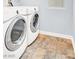 Laundry room features tile flooring and modern washer and dryer units at 3712 Gilmore Creek St, Las Vegas, NV 89129