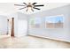 Bright living room features tile floors, natural light from two windows, and ceiling fan at 3712 Gilmore Creek St, Las Vegas, NV 89129