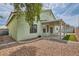 Backyard view with desert landscaping, covered patio, and a green exterior at 4318 Scarlet Vista Ct, North Las Vegas, NV 89031