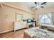 Spacious bedroom featuring twin beds, with a desk area, and a ceiling fan at 4318 Scarlet Vista Ct, North Las Vegas, NV 89031