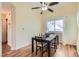 This dining room features hardwood floors, a modern ceiling fan and a window that brings in natural light at 4318 Scarlet Vista Ct, North Las Vegas, NV 89031