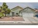 Charming single-story home featuring desert landscaping, attached garage, and neutral toned stucco exterior at 4318 Scarlet Vista Ct, North Las Vegas, NV 89031