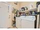 Functional laundry room featuring a washer, dryer, and shelving at 4318 Scarlet Vista Ct, North Las Vegas, NV 89031