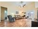 A bright living room offers plenty of space with hardwood floors, a ceiling fan, and large windows at 4318 Scarlet Vista Ct, North Las Vegas, NV 89031