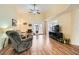 A bright living room offers plenty of space with hardwood floors, a ceiling fan, and large windows at 4318 Scarlet Vista Ct, North Las Vegas, NV 89031
