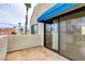 A balcony overlooks a sunny street with palm trees and other homes at 4391 Gannet Cir # 16, Las Vegas, NV 89103