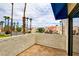 Balcony view of sunny street lined with palm trees and lush landscaping at 4391 Gannet Cir # 16, Las Vegas, NV 89103