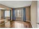 Spacious bedroom features hardwood floors, a large window, and a mirrored closet at 4391 Gannet Cir # 16, Las Vegas, NV 89103