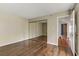 Empty bedroom boasts hardwood floors, an open door, and mirrored closet at 4391 Gannet Cir # 16, Las Vegas, NV 89103